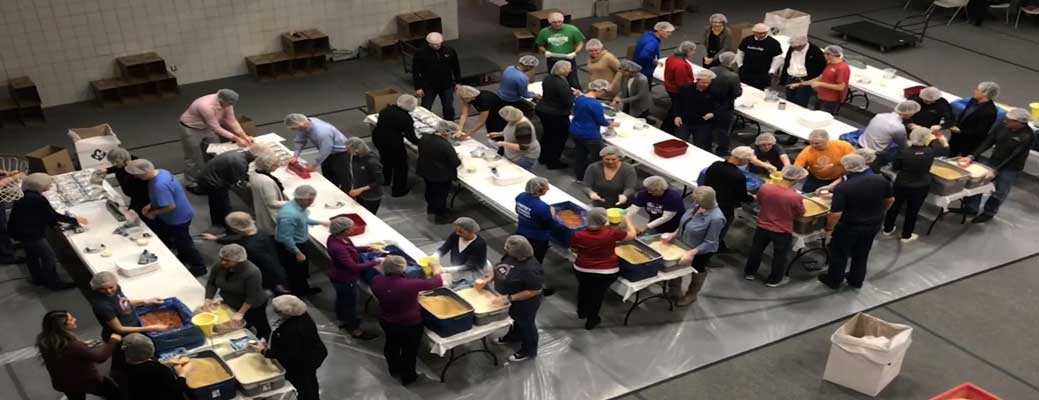 Employees packaging meal donations
