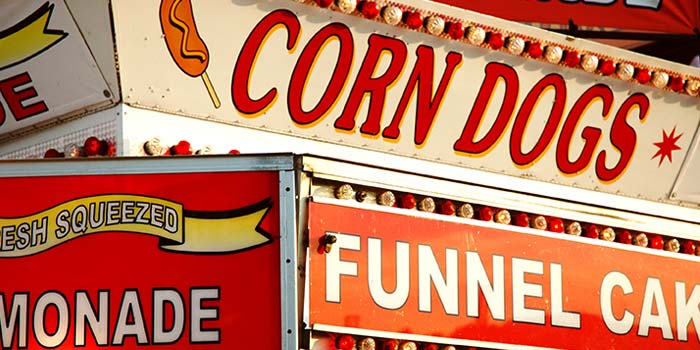 A collection of signs advertising State Fair style foods.