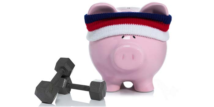 An image of a piggy bank wearing a headband, posed with dumbells