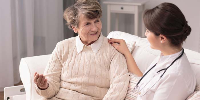 Elderly woman talking to a home health care provider.