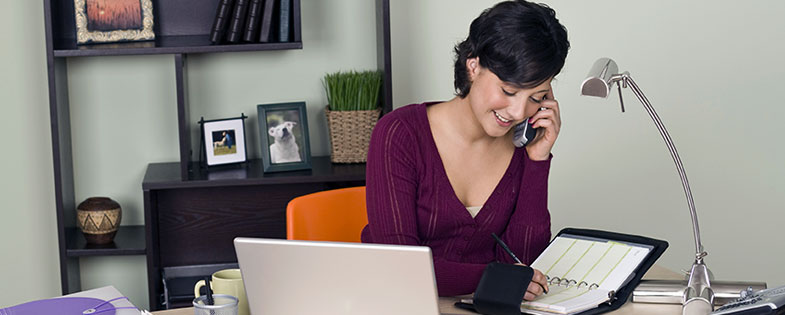 Woman working at desk in her home-based business