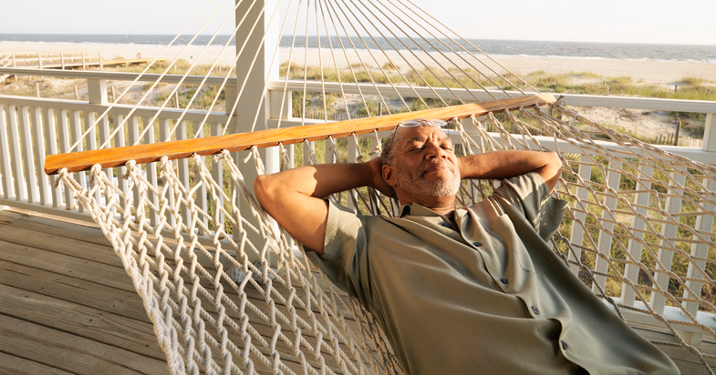 Retired man sleeping on hammock